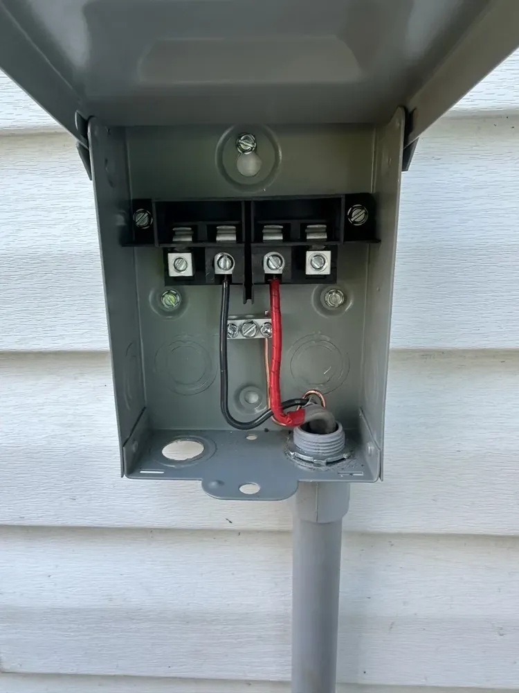 Ductless mini-split outdoor heat pump electrical hookups and isolator switch - Work completed by Mills Electric Co.