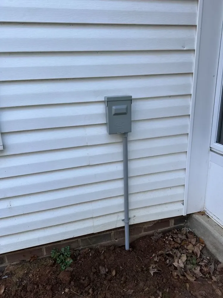 Ductless mini-split outdoor heat pump electrical hookups and isolator switch - Work completed by Mills Electric Co.