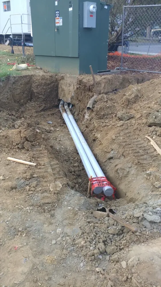 Commercial electrical underground trenches, feeders, and utility transformer connections - Work completed by Mills Electric Co.